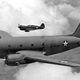 A C-46 Commando is escorted by a Curtiss P-40 Warhawk in 1943 (US Army)
